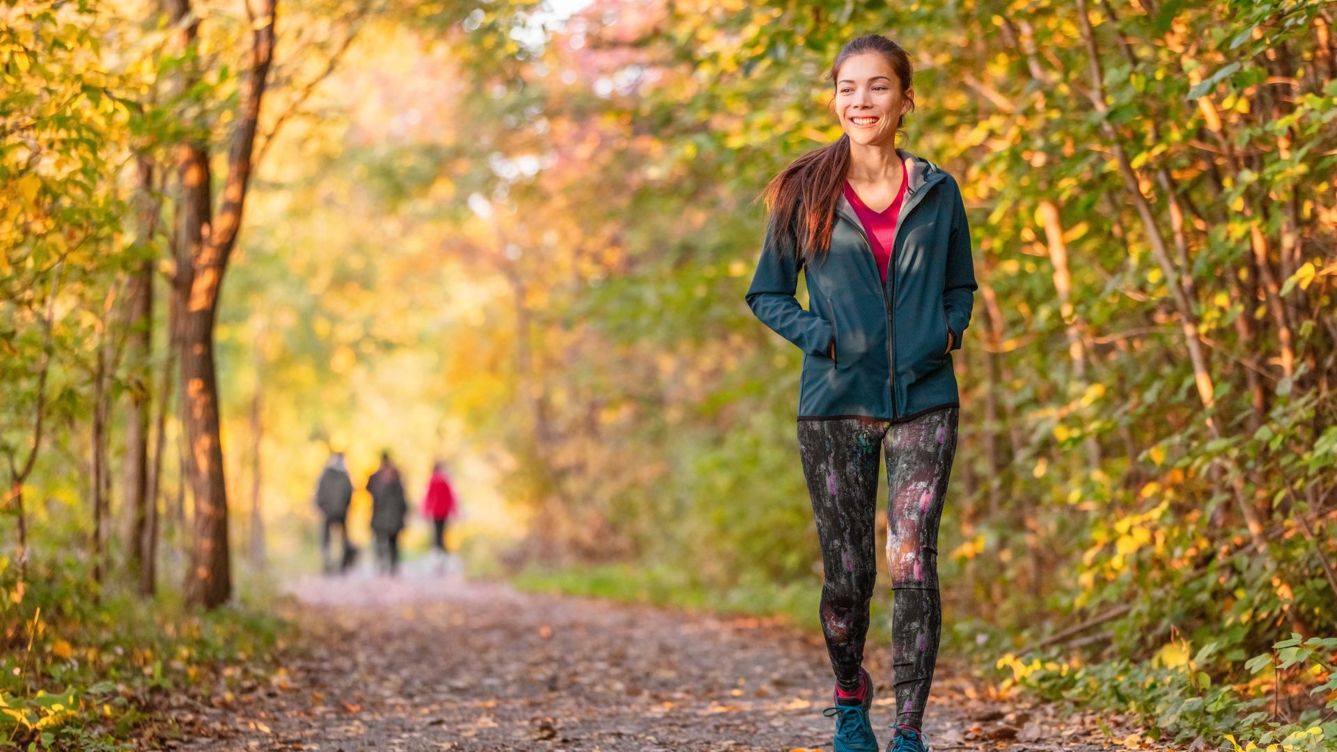 Woman walking on a trail in the woods